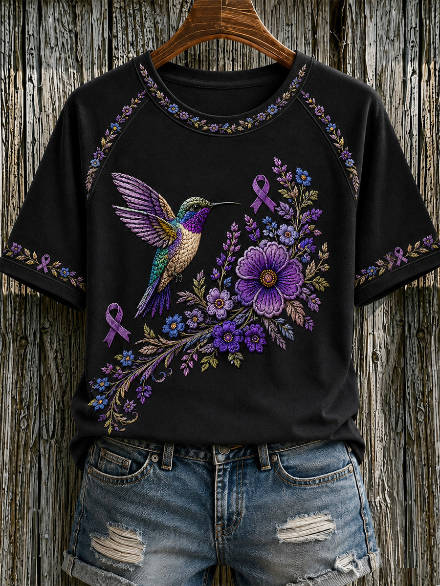 Damen-T-Shirt in Lila mit Blumen- und Kolibri-Print zur Sensibilisierung für Alzheimer