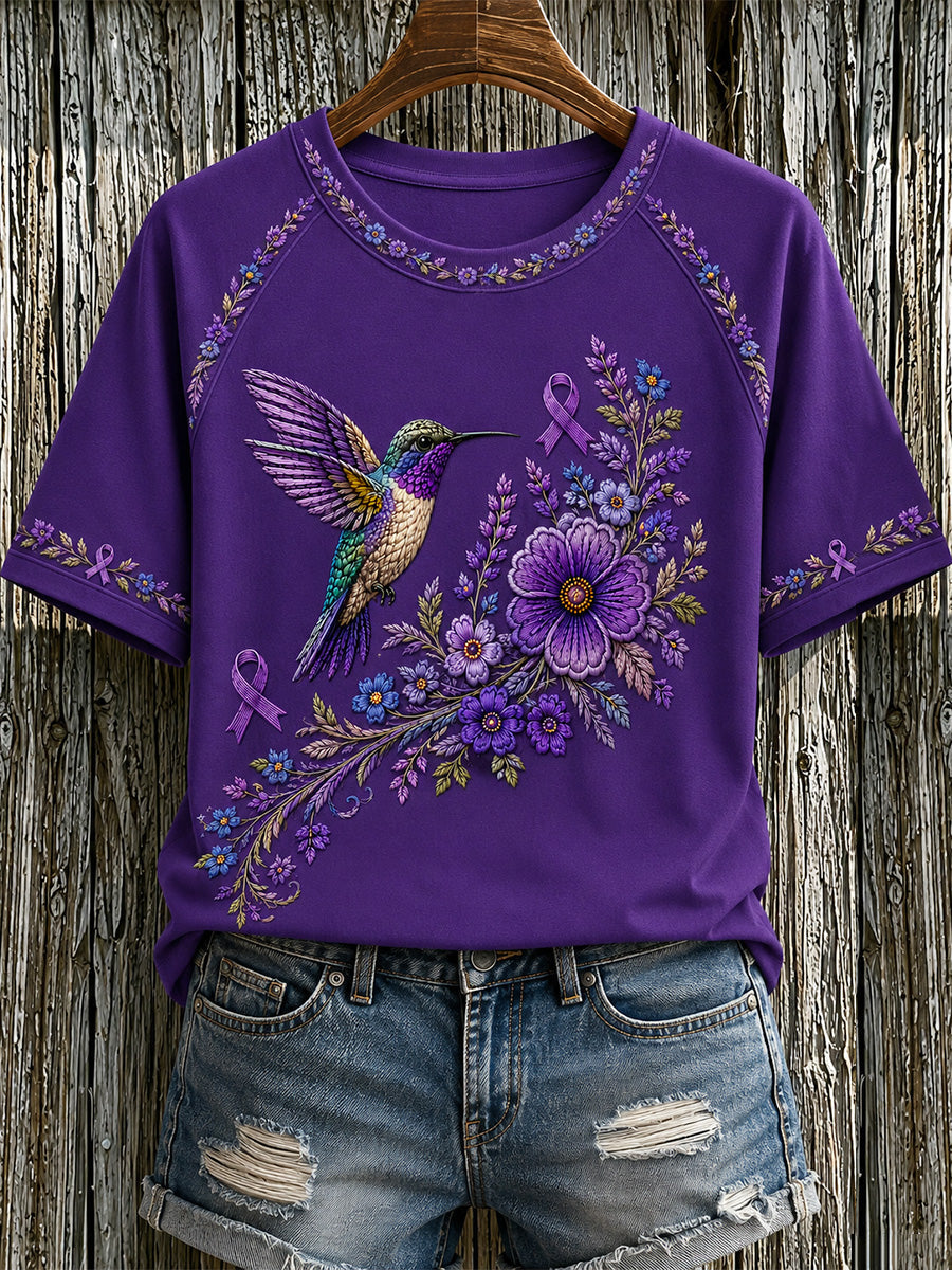 Damen-T-Shirt in Lila mit Blumen- und Kolibri-Print zur Sensibilisierung für Alzheimer