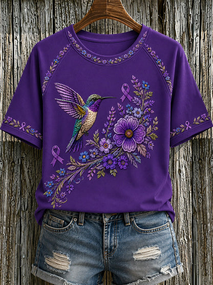 Damen-T-Shirt in Lila mit Blumen- und Kolibri-Print zur Sensibilisierung für Alzheimer