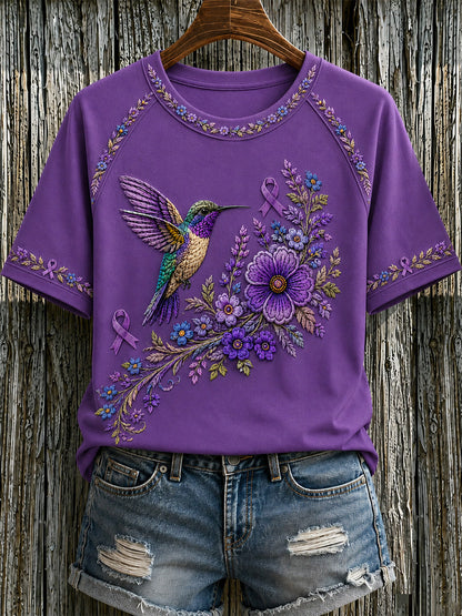 Damen-T-Shirt in Lila mit Blumen- und Kolibri-Print zur Sensibilisierung für Alzheimer