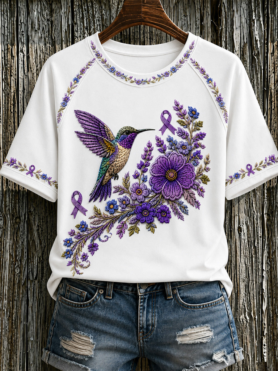 Damen-T-Shirt in Lila mit Blumen- und Kolibri-Print zur Sensibilisierung für Alzheimer